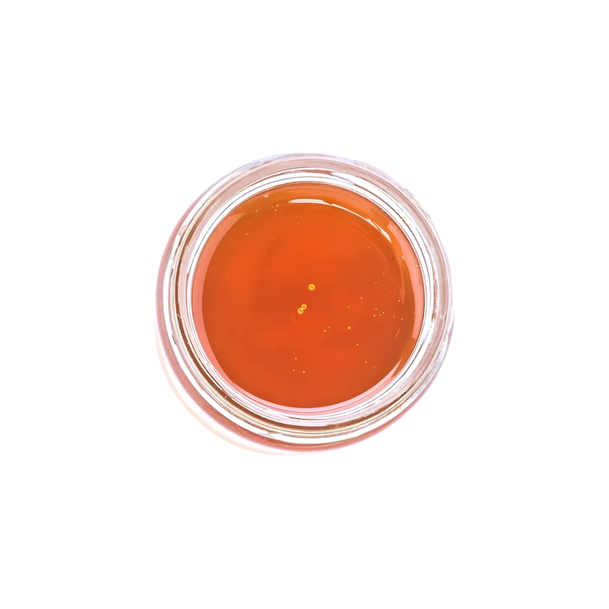 Vue du dessus du sirop de gingembre Dormoy, texture fluide et couleur ambrée, parfait pour boissons et préparations culinaires épicées.